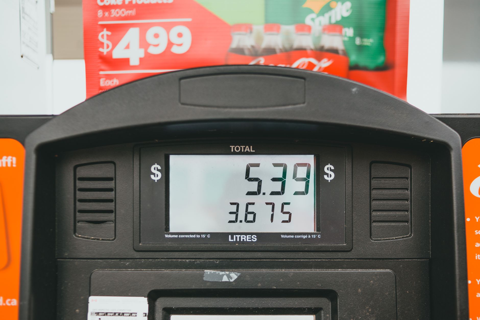 Close-up of a gas pump display showing price per liter and total volume during a transaction.
