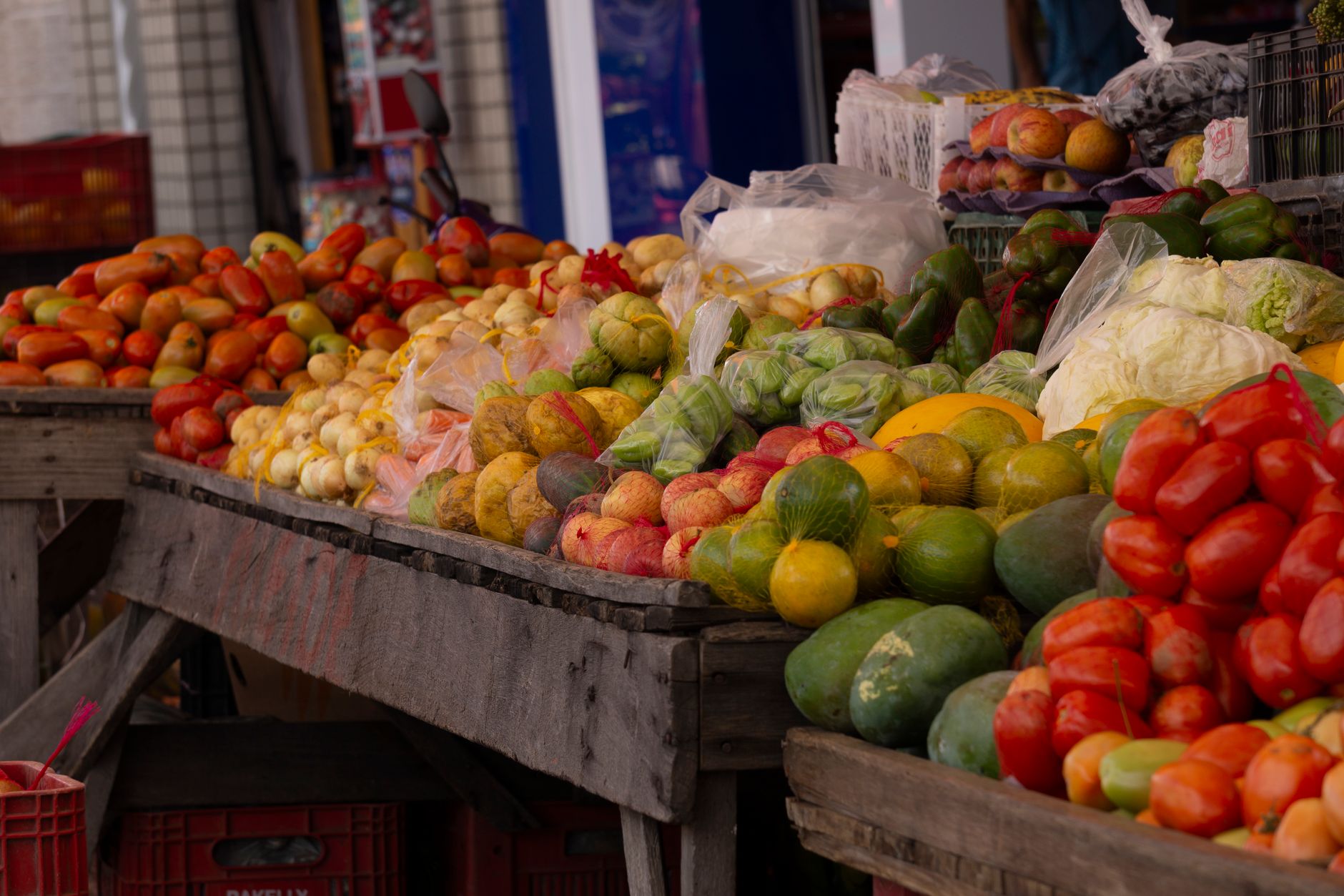 Vibrant outdoor market stall showcasing a variety of fresh fruits and vegetables.