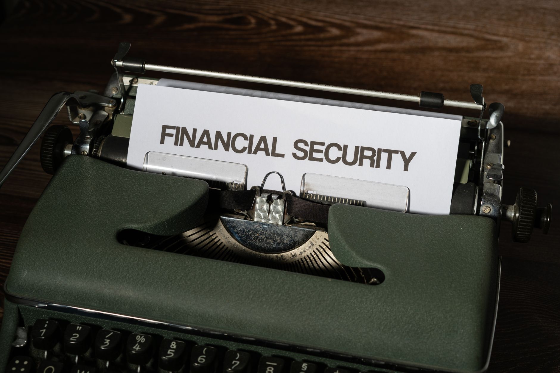 A vintage typewriter displaying a paper with the words 'Financial Security'.